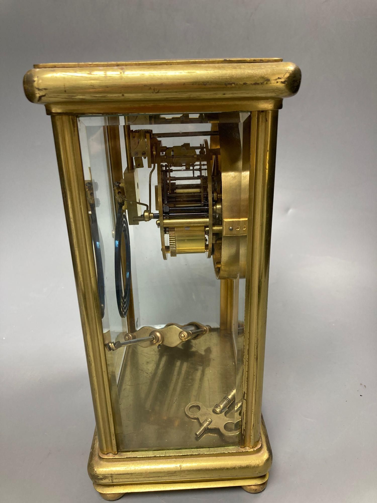 A four glass and brass mantel clock with mercury pendulum, 18cm high, 17cm wide,13cm deep